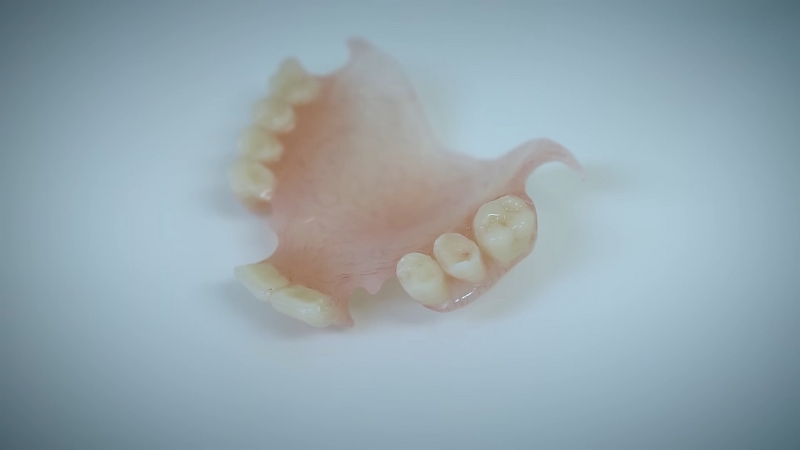 A close-up of partial dentures placed on a clean surface