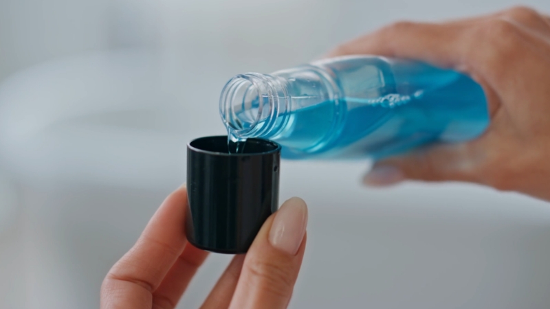 Mouthwash poured into a small cap before use