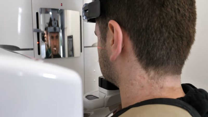 Person Undergoing a Dental X-Ray Scan with A Focused Laser Alignment