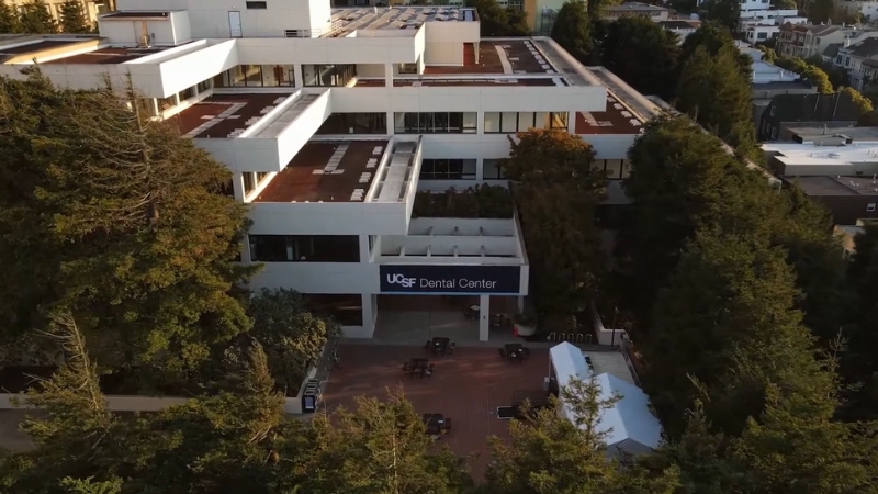 The UCSF Dental Center Building with Surrounding Trees and Outdoor Seating Area