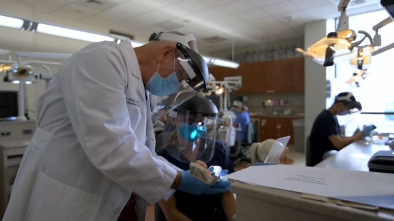 A Faculty Member Assists a Dental Student at The University of Connecticut School of Dental Medicine